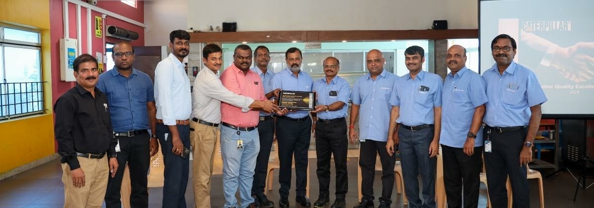 picture of the team in india receiving the award from caterpillar