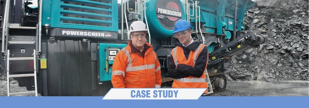 Picture of Terex and Poclain experts in front of a jaw crusher