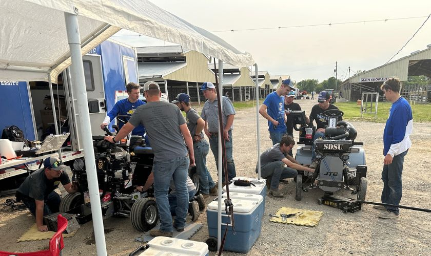 the team doing maintenance on the tractor